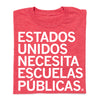 Red heather RAYGUN t-shirt with white text that reads ESTADOS UNIDOS NECESITA ESCUELAS PÚBLICAS.