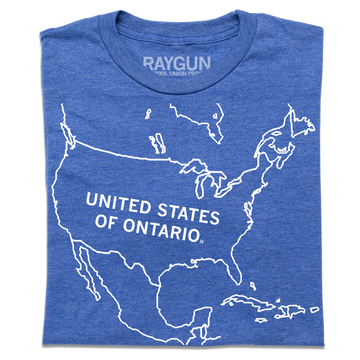 A folded heather blue t-shirt with a white ink outline of North America with "UNITED STATES OF ONTARIO" printed inside the USA.