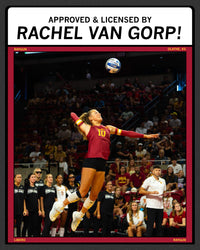 A collegiate volleyball player in a maroon and gold jersey jumps to spike a ball during a game in a crowded arena, wearing a Heather Red T-shirt featuring the text Approved & Licensed by Rachel Van Gorp! and RAYGUN.