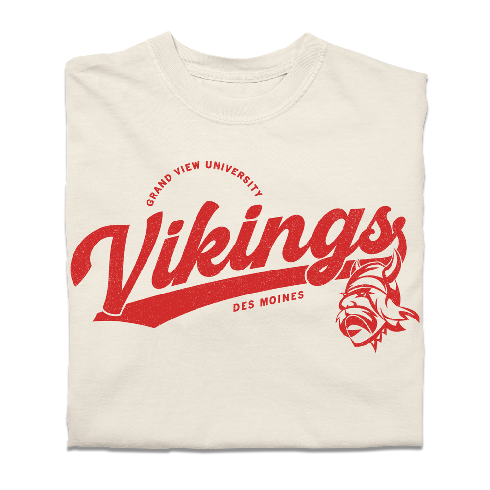 Ivory Comfort Colors shirt with red script text that reads "Grandview University Vikings. Des Moines" with an illustration of the viking logo.
