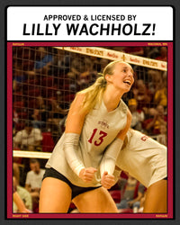 Iowa State volleyball player Lilly Wachholz, wearing a jersey numbered 13, cheers on the court while dressed in a heather red T-shirt.