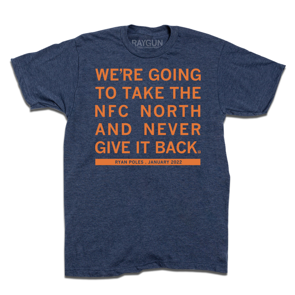 A heather denim tee with orange ink print that says, "We're going to take the NFC North and never give it back. Ryan Poles, January 2022"