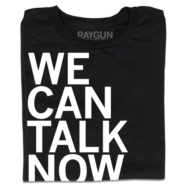 A folded black t-shirt with left-aligned white ink text that reads 