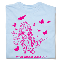 A folded pastel blue heavyweight t-shirt with hot pink ink depicting Dolly Parton with open arms, surrounding by butterflies and sparkles. All caps text below says, "WHAT WOULD DOLLY DO?"