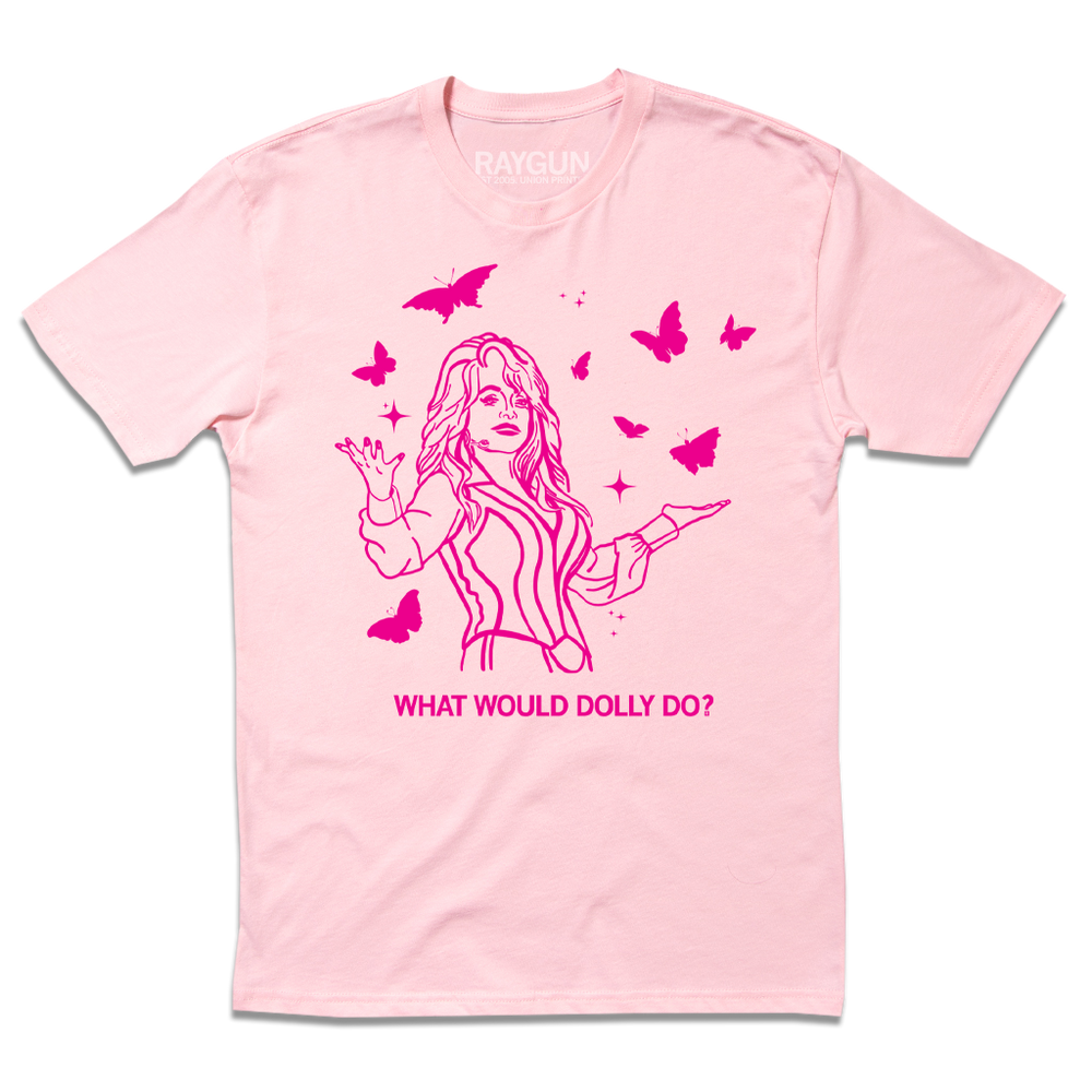 Short sleeve light pink t-shirt with hot pink ink depicting Dolly Parton with open arms, surrounding by butterflies and sparkles. All caps text below says, "WHAT WOULD DOLLY DO?"