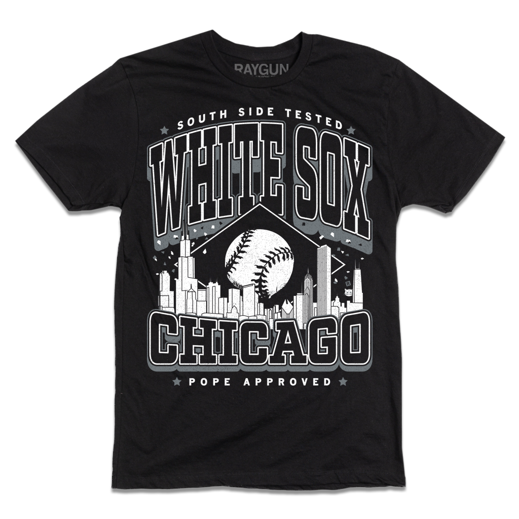 Black t-shirt with white ink. Text reads "South Side tested. White Sox Chicago. Pope approved." with the Chicago skyline in the center and a baseball above it.