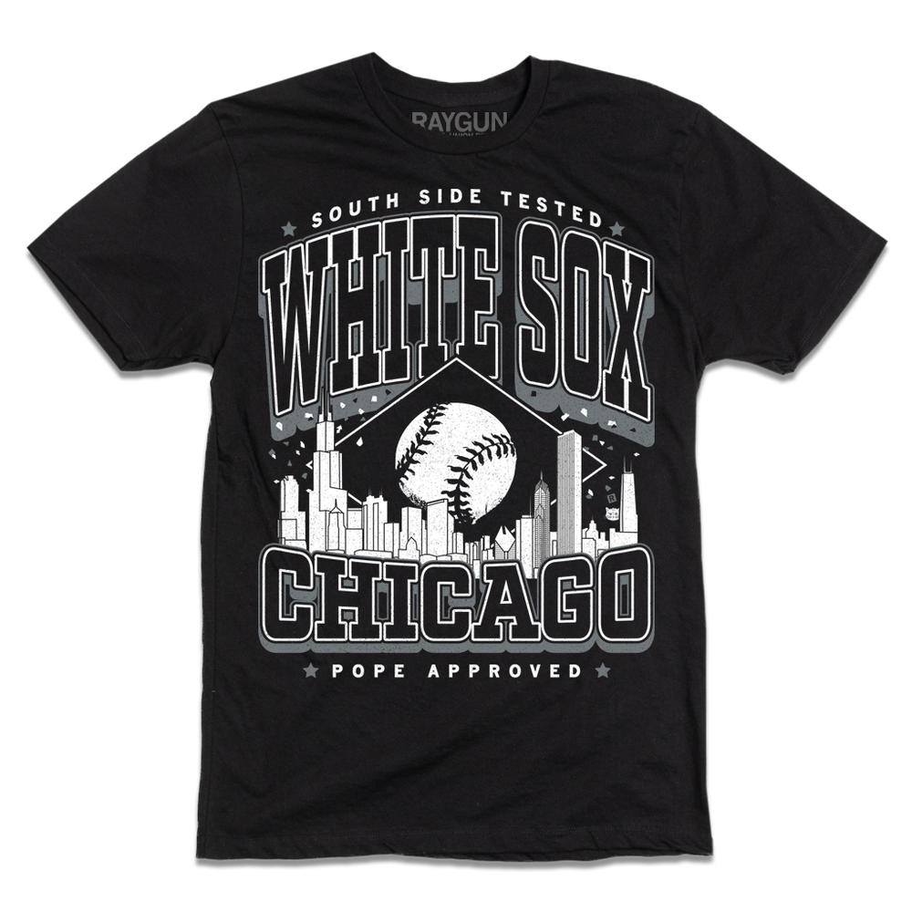 Black t-shirt with white ink. Text reads "South Side tested. White Sox Chicago. Pope approved." with the Chicago skyline in the center and a baseball above it.
