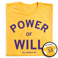 A folded heather gold t-shirt that says "Power of Will. Will Hornseth #13" in purple ink on the front and "Hornseth 13" on the back