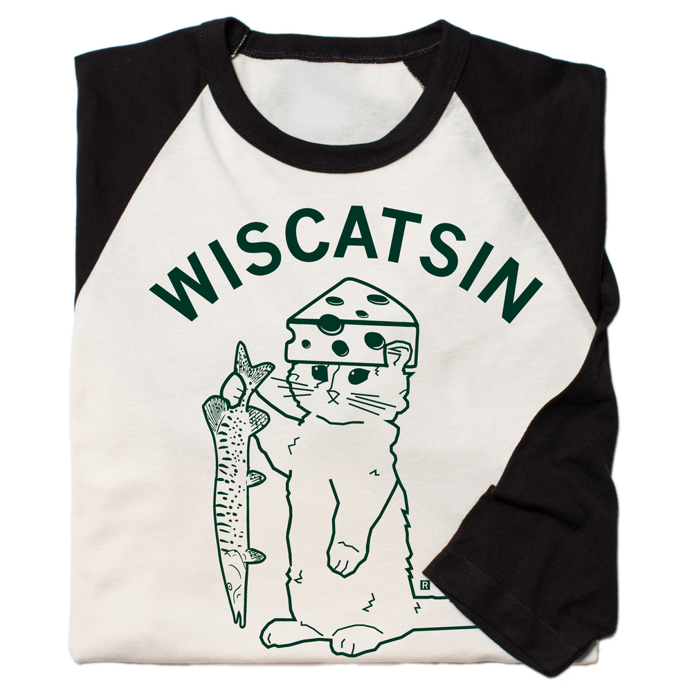 Folded vintage white baseball tee with black 3/4 sleeves and black color. Dark green curved text near the top says, "Wiscatsin" above an illustration of RAYGUN's cat mascot, Gary, wearing a cheese hat and holding a fist.