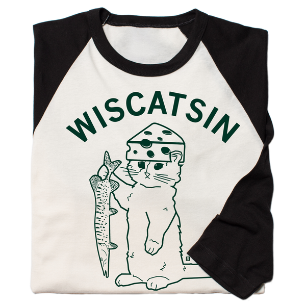 Folded vintage white baseball tee with black 3/4 sleeves and black color. Dark green curved text near the top says, 