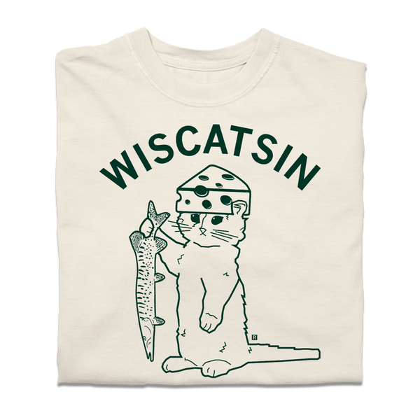 A folded ivory heavyweight t-shirt with dark green ink. Curved text near the top says, 