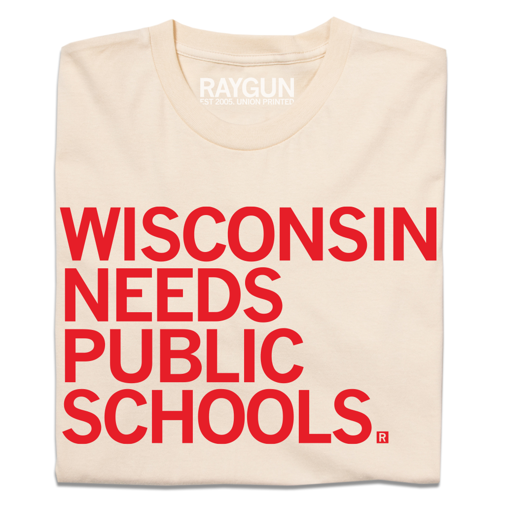 Cream-colored t-shirt featuring the red text WISCONSIN NEEDS PUBLIC SCHOOLS, a design that supports public education.