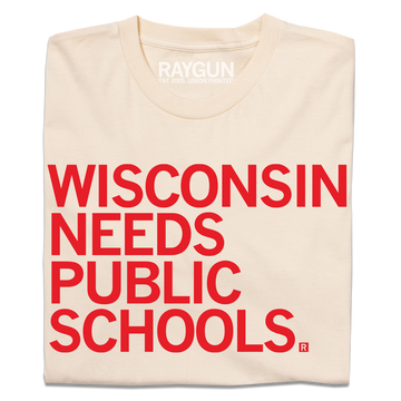 Cream-colored t-shirt featuring the red text WISCONSIN NEEDS PUBLIC SCHOOLS, a design that supports public education.