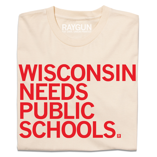 Cream-colored t-shirt featuring the red text WISCONSIN NEEDS PUBLIC SCHOOLS, a design that supports public education.