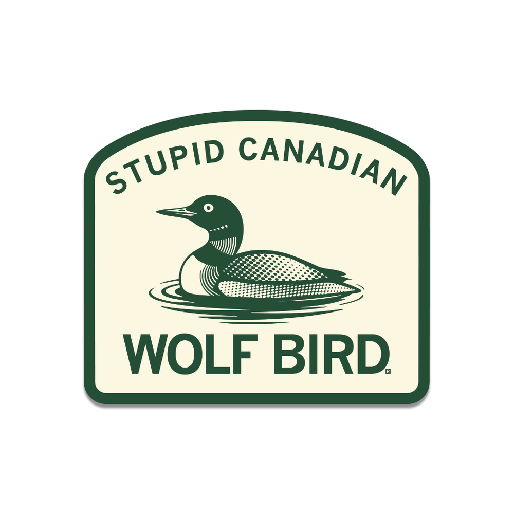 A green & cream die-cut sticker with curved text at the top that reads "Stupid Canadian" pairing with text at the bottom that says, "Wolf Bird." In the center is a wolf bird aka common loon.