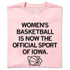 Light pink women’s basketball t-shirt featuring the text WOMENS BASKETBALL IS NOW THE OFFICIAL SPORT OF IOWA above a basketball silhouette inside an outline of the state of Iowa.