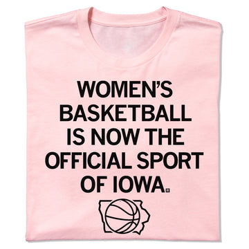 Light pink women’s basketball t-shirt featuring the text WOMENS BASKETBALL IS NOW THE OFFICIAL SPORT OF IOWA above a basketball silhouette inside an outline of the state of Iowa.
