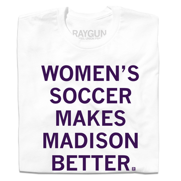 A folded white t-shirt with centered purple ink that says, "Women's soccer makes Madison better."