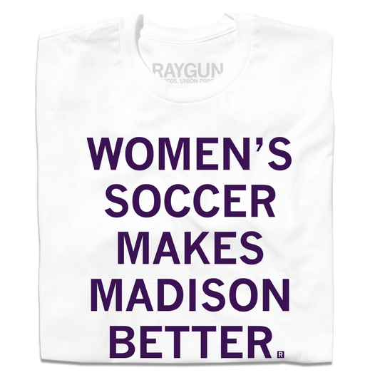 A folded white t-shirt with centered purple ink that says, "Women's soccer makes Madison better."