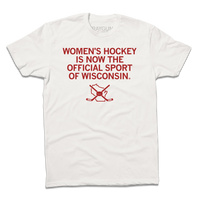 A dull white shirt with centered red in text that reads "Women's Hockey is now the Official Sport of Wisconsin" over an outline of Wisconsin with crossed hockey sticked and a puck centered on top of it.