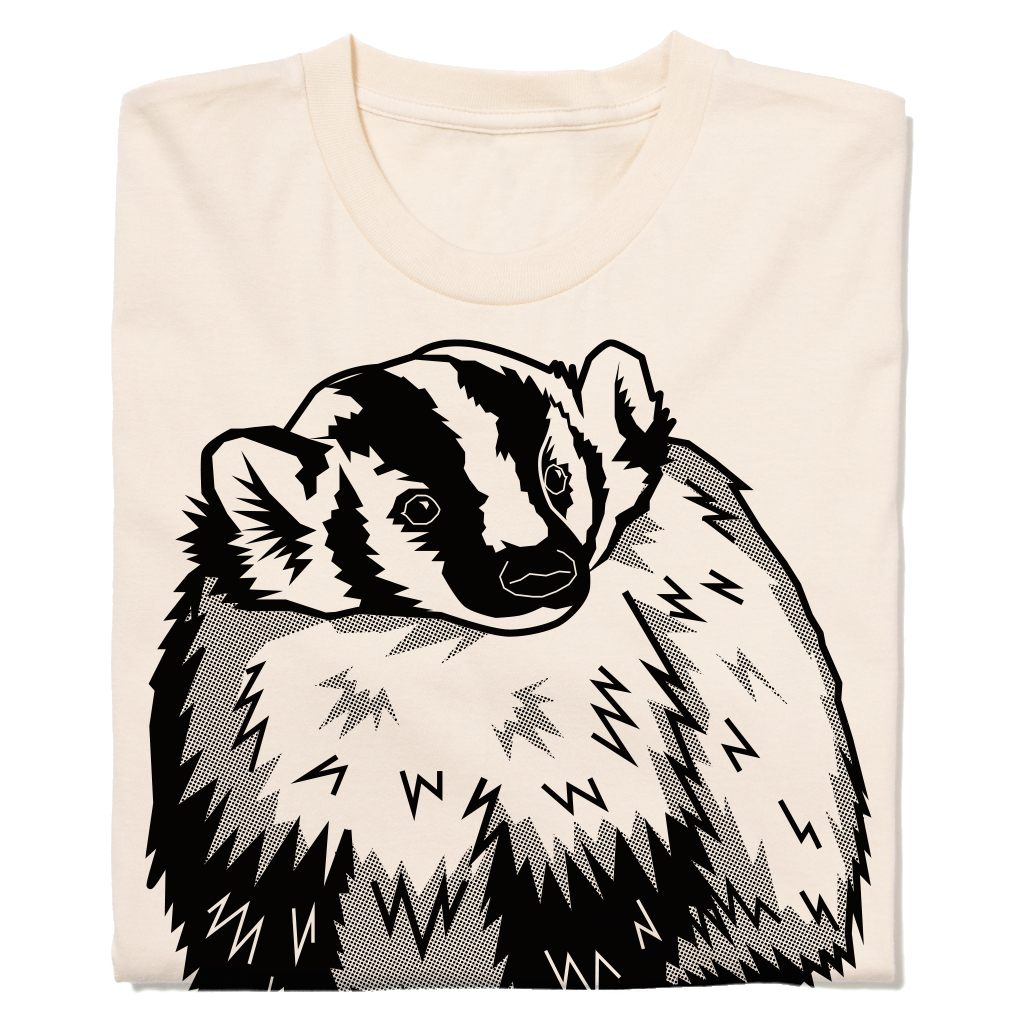 A cream-colored natural t-shirt featuring a black and white graphic of a badger.