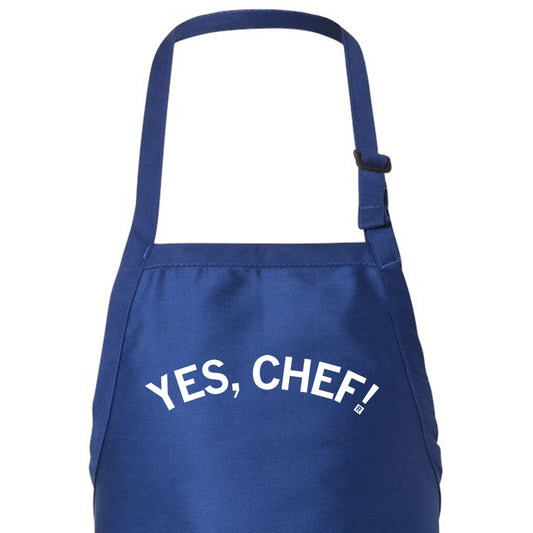 A blue chef apron with the white text YES, CHEF! printed on the front.