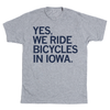 A short-sleeve heather grey t-shirt with all caps navy ink that says, "YES, WE RIDE BICYCLES IN IOWA."