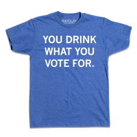 Short-sleeve heather royal blue t-shirt with centered white text that says, "You Drink What You Vote For" in all caps.