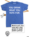 Promo image of the same shirt with Gary adding "Watch out! You may get a big glass of inept public policy!"