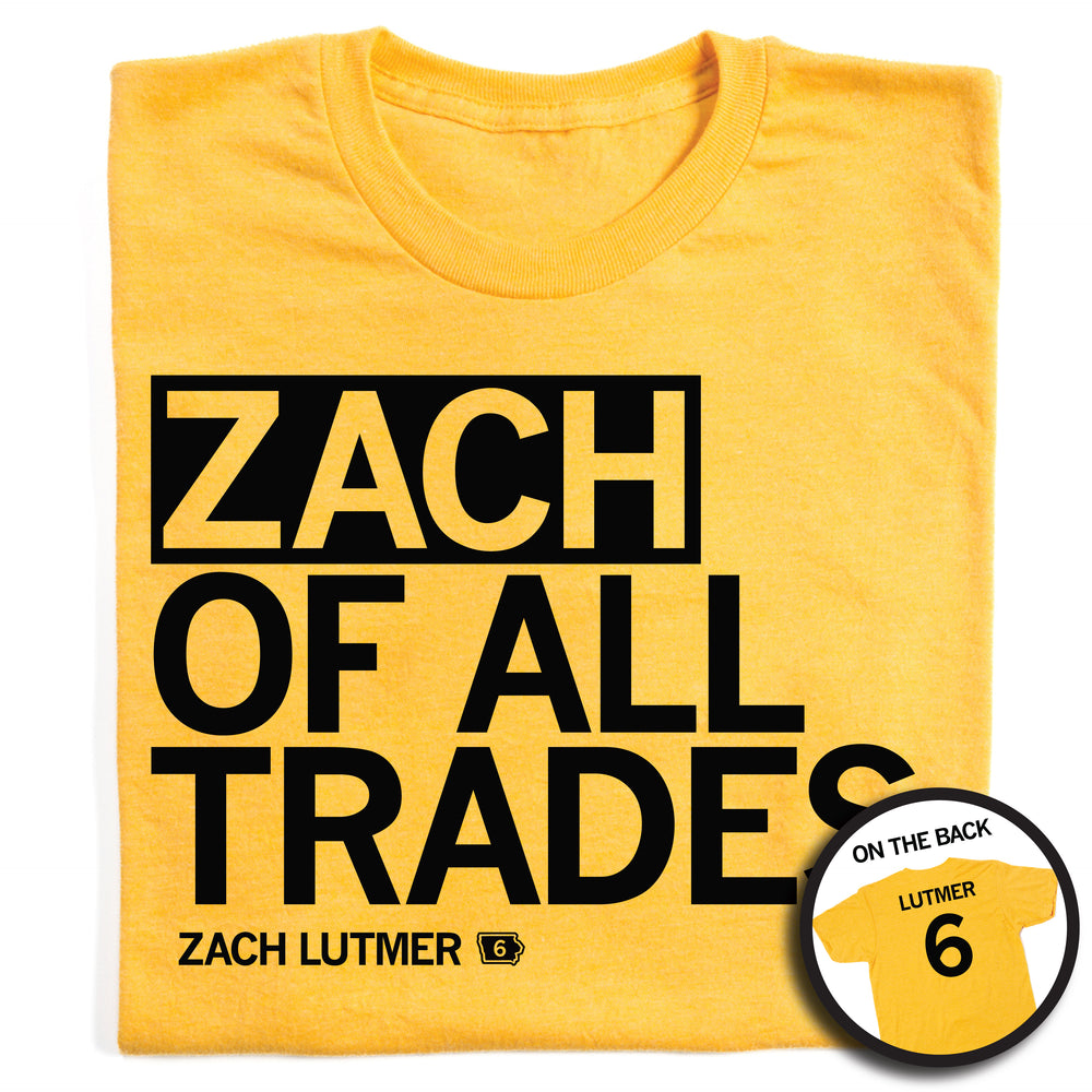 A folded heather yellow t-shirt with left-aligned black text that says, "ZACH OF ALL TRADES" with "ZACH LUTMER" in smaller text below. To the right of his name is an outline of Iowa with the number "6" in its center. A circular picture to the bottom right shows the back of the shirt. The back is printed like a jersey with "LUTMER" above a large 6.