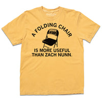 A laid flat mustard gold shirt with the text "a folding chair is more useful than Zach Nunn" in black ink around the illustration of a folding chair