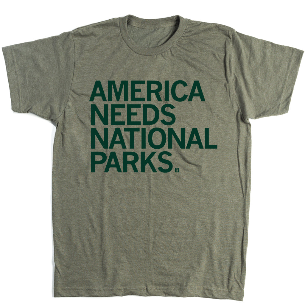 Heather olive t-shirt with left aligned forest green text that says, "America Needs National Parks"