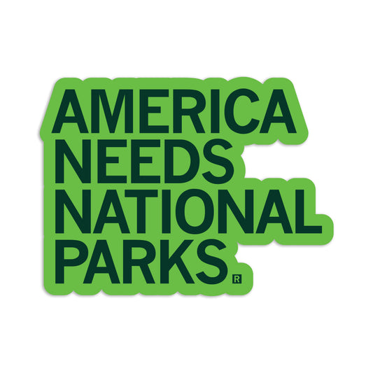 A vinyl sticker with the text AMERICA NEEDS NATIONAL PARKS in bold dark green letters on a bright green background.