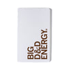 White notebook with a screen-printed brown design that reads BIG D&D ENERGY on the cover.