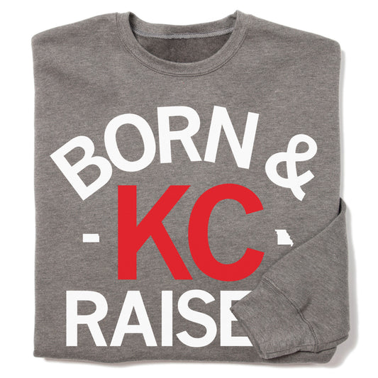 Grey Kansas City sweatshirt featuring the white and red text BORN & KC RAISED with a small white outline of the state of Missouri.