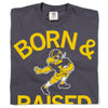 Charcoal gray union-made Raygun t-shirt with the yellow text BORN & RAISED and an illustration of a football-playing bird mascot in the center.