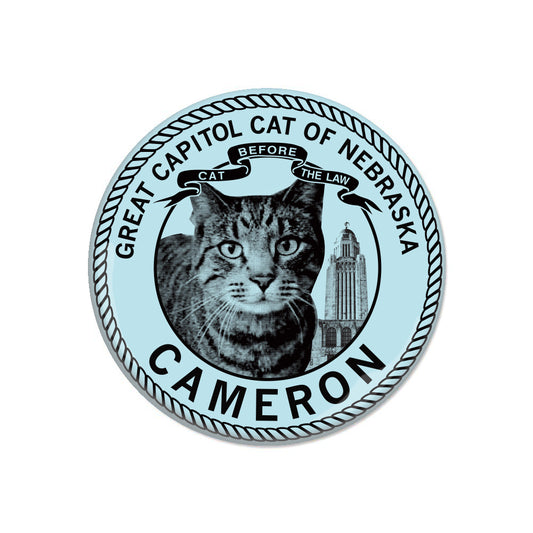 Circular RAYGUN sticker featuring a cat, the Nebraska State Capitol, and the text Great Capitol Cat of Nebraska, Cameron, and Before Cat The Law.