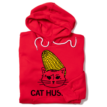 A red RAYGUN pullover hoodie featuring a graphic of a cat with a corn cob on its head and the text CAT HUS.