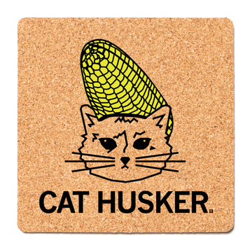 Square RAYGUN cork coaster featuring a black line drawing of a cat with a yellow ear of corn on its head, with the text CAT HUSKER below.