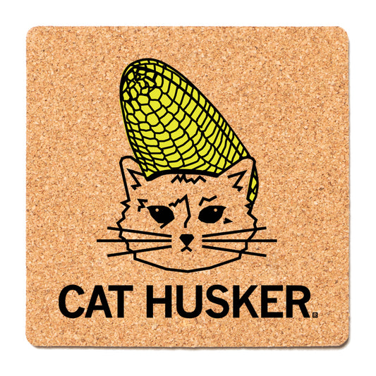 Square RAYGUN cork coaster featuring a black line drawing of a cat with a yellow ear of corn on its head, with the text CAT HUSKER below.