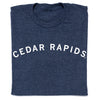 Folded heather denim t-shirt in navy blue with CEDAR RAPIDS printed in a white, arched font.