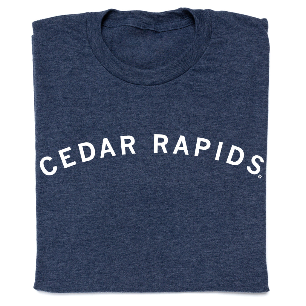 Folded heather denim t-shirt in navy blue with CEDAR RAPIDS printed in a white, arched font.