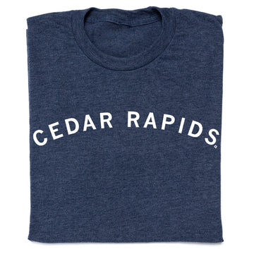 Folded heather denim t-shirt in navy blue with CEDAR RAPIDS printed in a white, arched font.