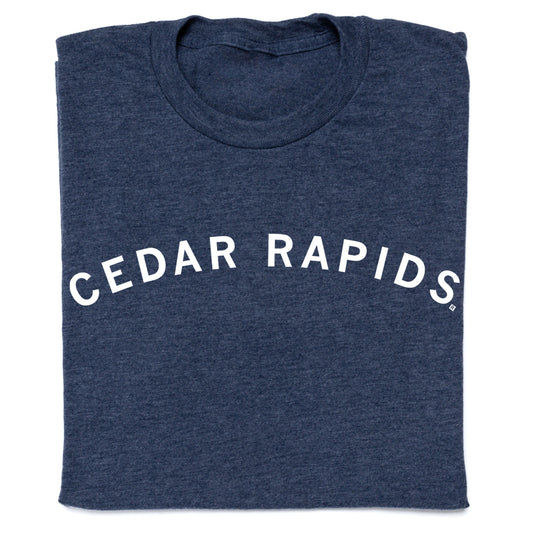 Folded heather denim t-shirt in navy blue with CEDAR RAPIDS printed in a white, arched font.
