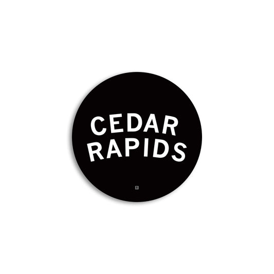 Black circular Cedar Rapids vinyl sticker with the words CEDAR RAPIDS in white capital letters.