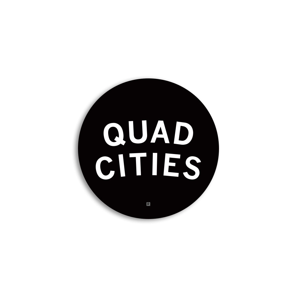 A round black RAYGUN vinyl sticker with the white text QUAD CITIES and a small R symbol at the bottom.