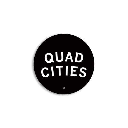 A round black RAYGUN vinyl sticker with the white text QUAD CITIES and a small R symbol at the bottom.