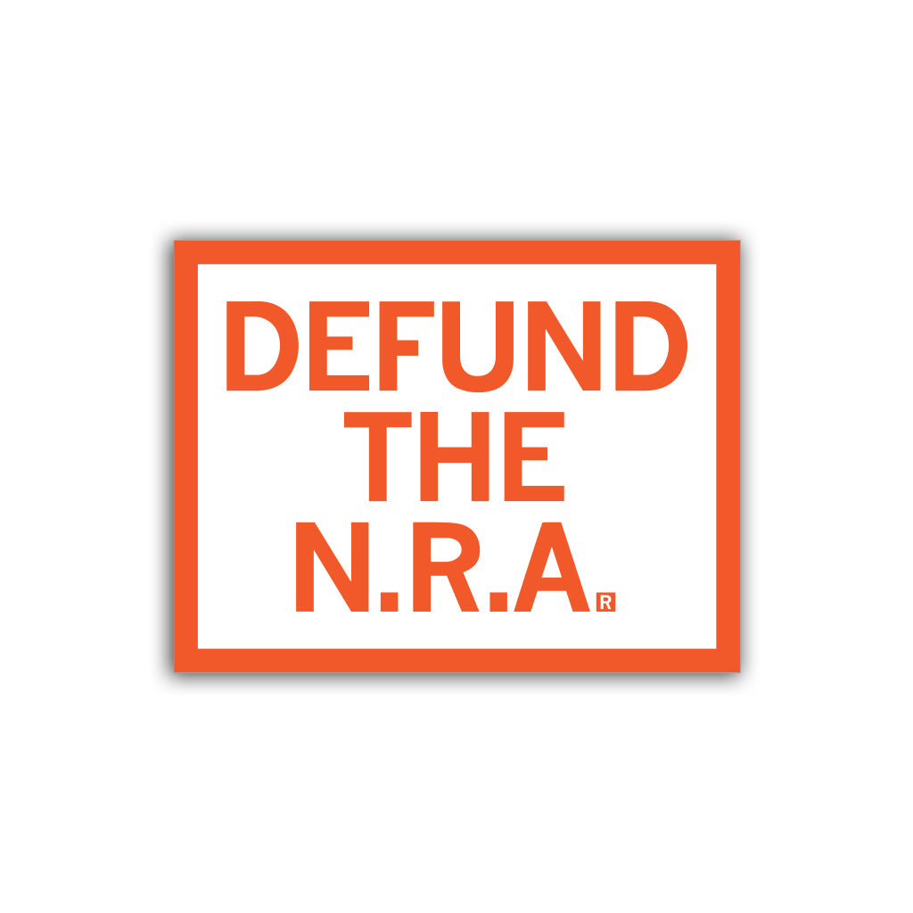 White RAYGUN vinyl sticker with an orange border reading DEFUND THE N.R.A. in orange capital letters.