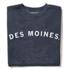 A charcoal grey RAYGUN crewneck sweatshirt with the text DES MOINES printed in white across the chest.