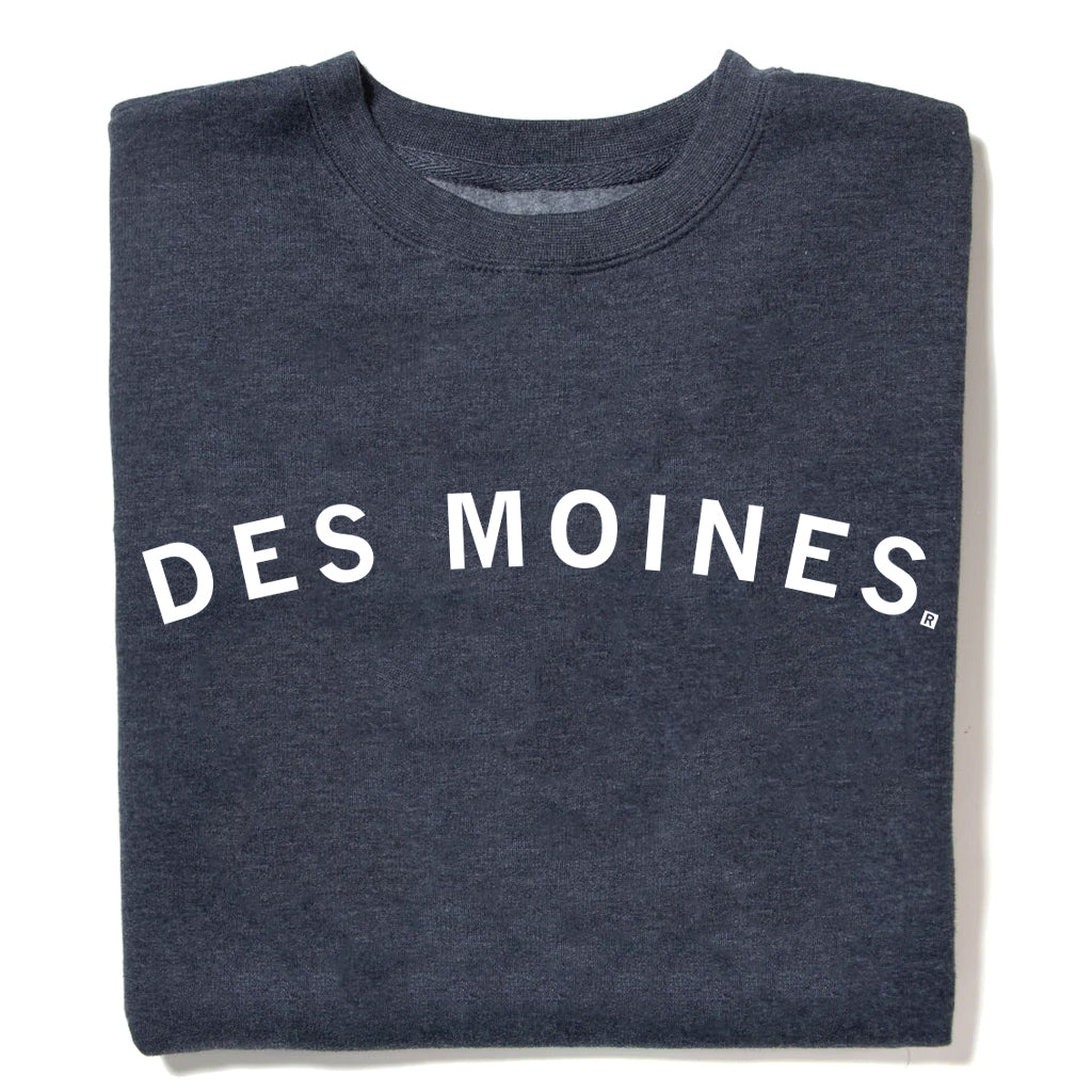A charcoal grey RAYGUN crewneck sweatshirt with the text DES MOINES printed in white across the chest.